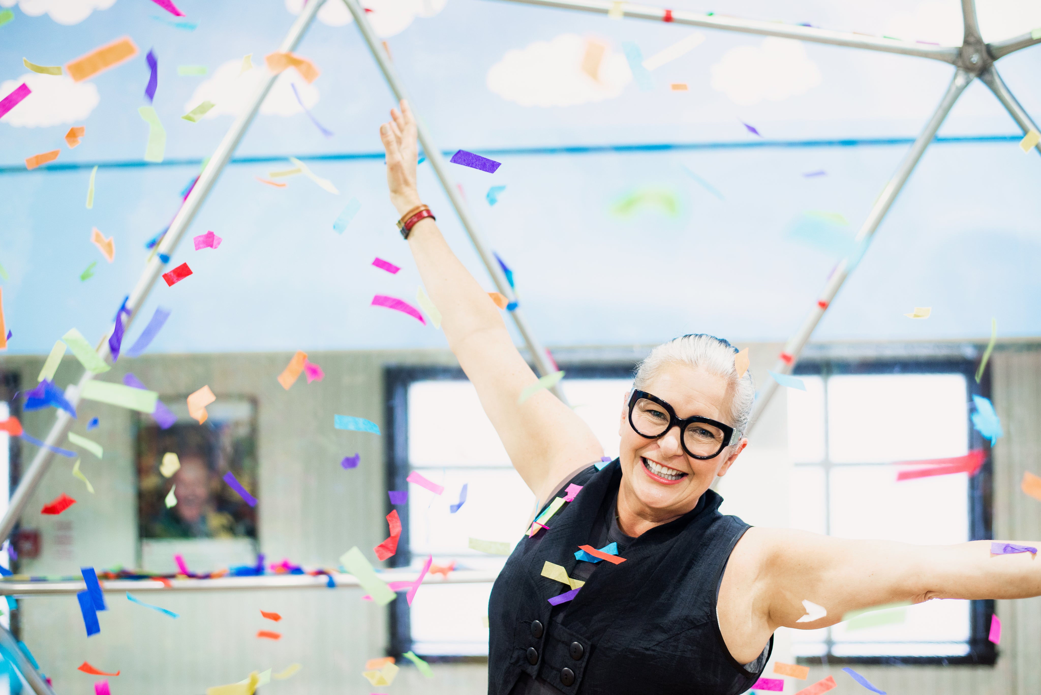 files/woman-throws-arms-in-air-as-rainbow-confetti-falls-around-her.jpg